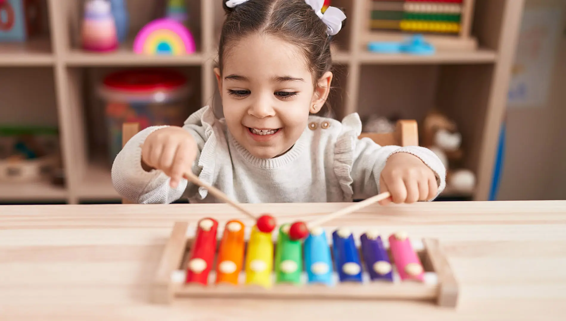 A girl playing with a xylophone